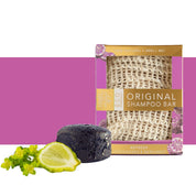 View of the whitening lemongrass and bergamot Hairy Pony Eco-Friendly Shampoo Bar with a bergamot on a purple and white color block background