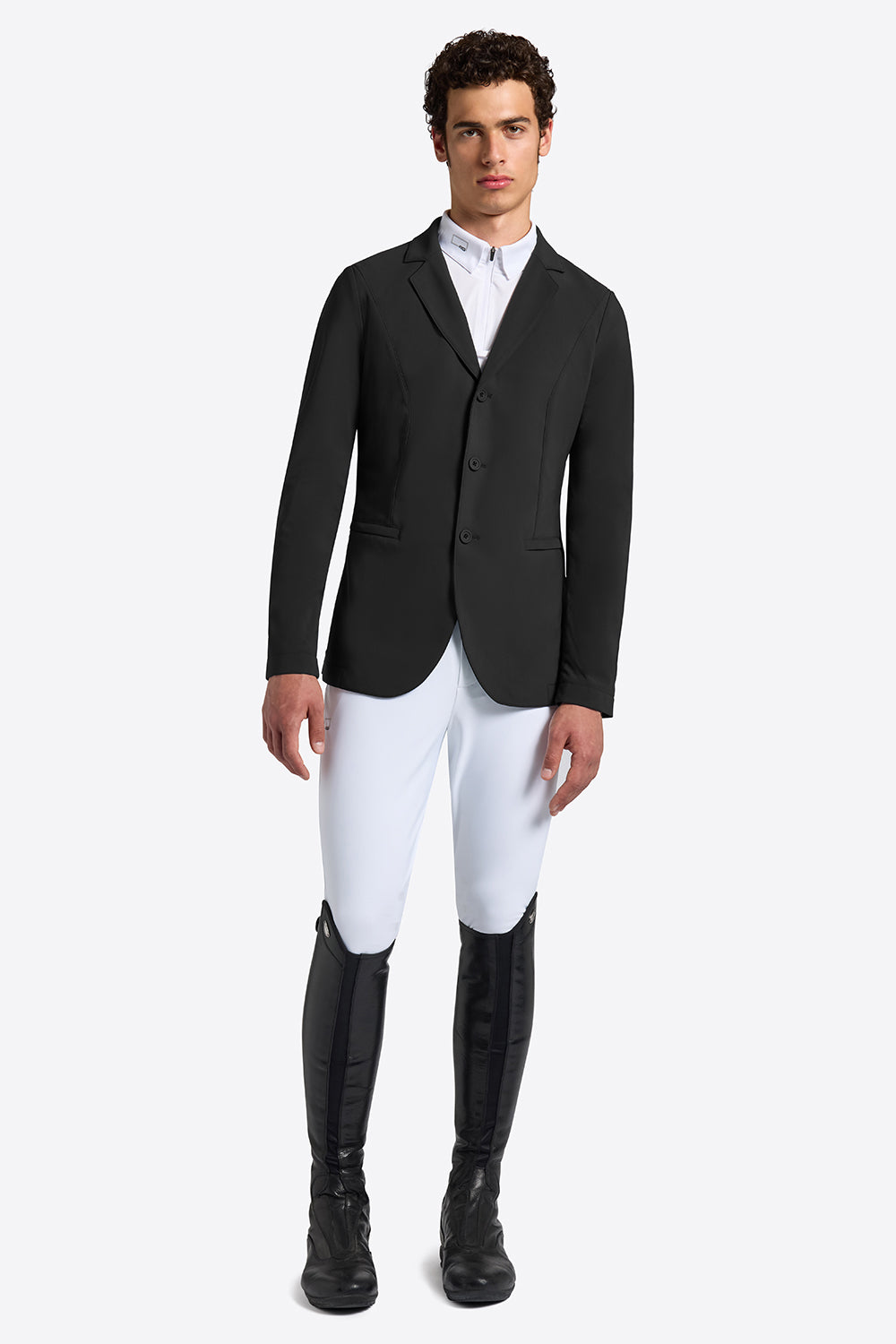 Rider’s Gene men’s black jersey competition jacket, front view, worn with white breeches and tall black riding boots