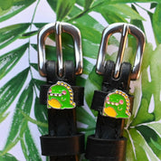 Close-up view of the Dragon Mane Jane Spur Straps on a tropical background