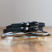 Front view of the buckled Octopus Mane Jane Spur Straps on wood