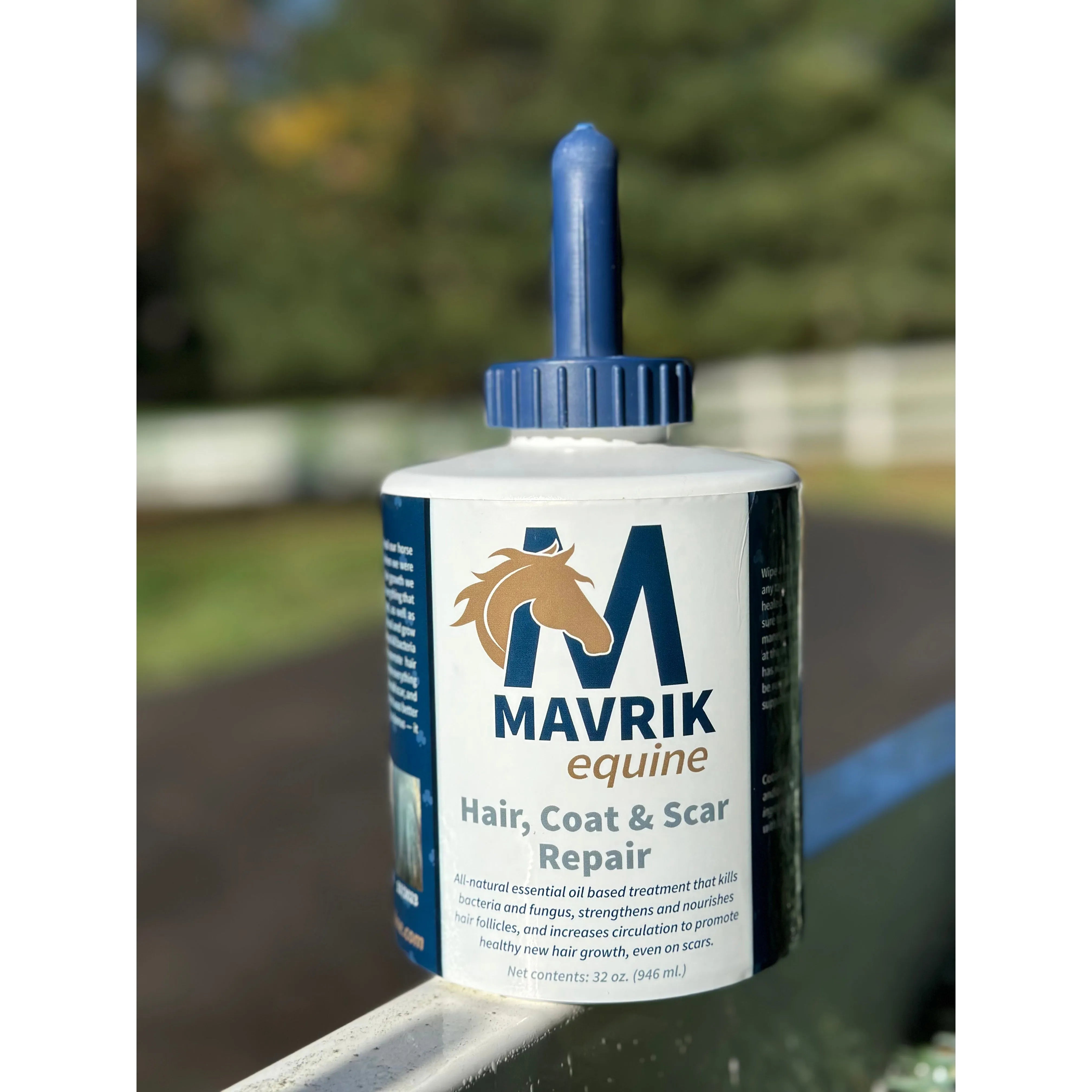 Front view of a 32 oz bottle of Mavrik Equine Hair, Coat & Scar Repair on a fence outside