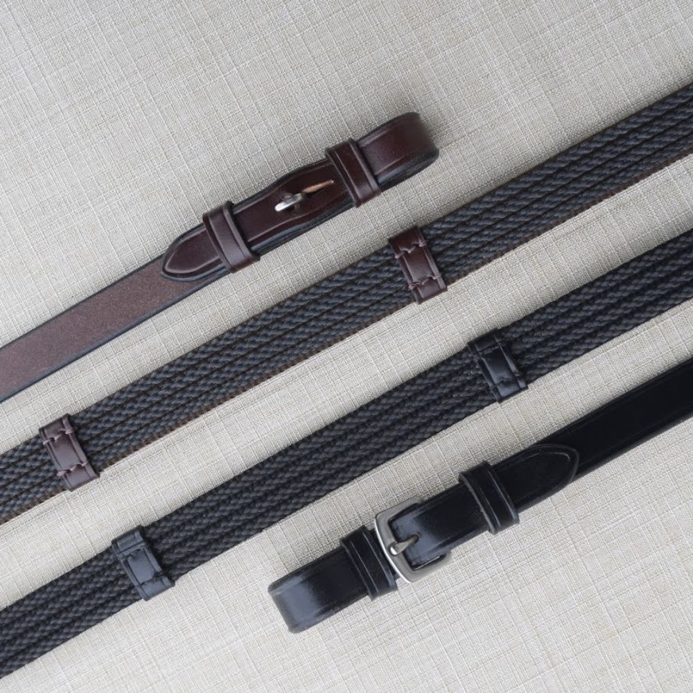 Side-by-side front and back views of a pair of black buckle and brown pin Red Barn Special Grip Reins on a patterned background