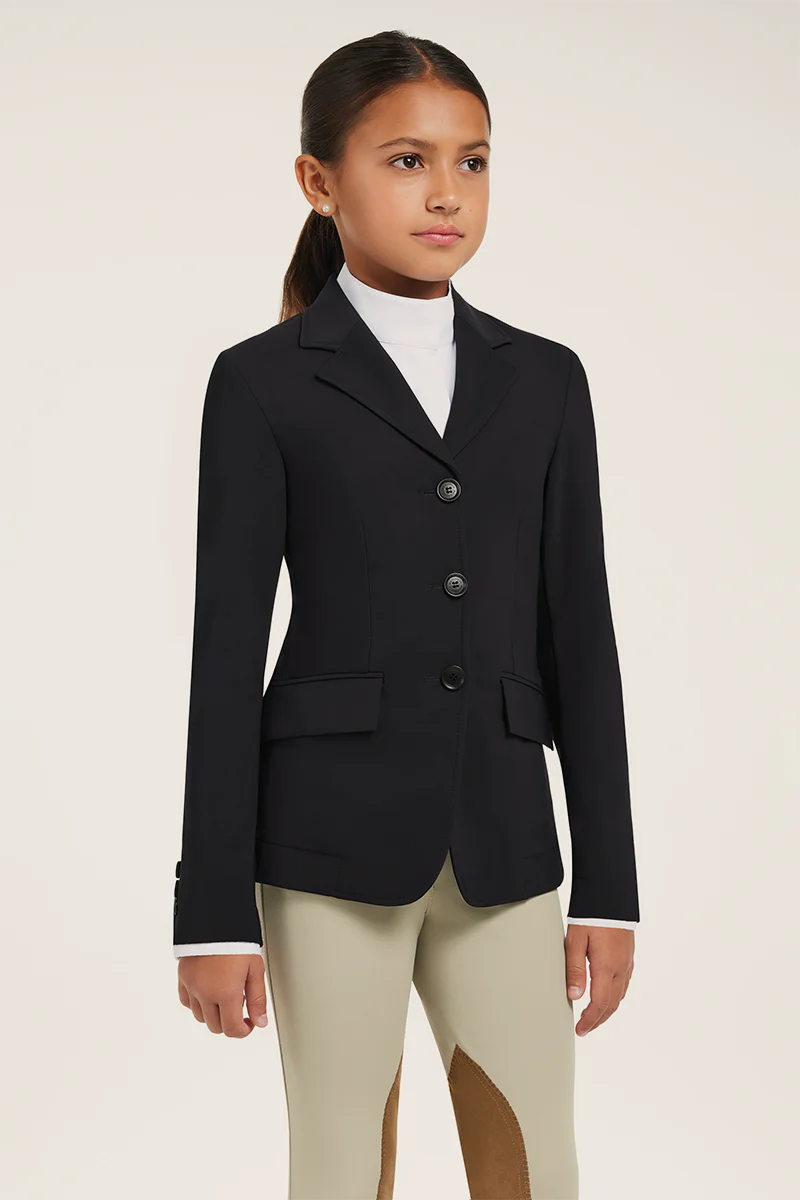 Front view of a young female model wearing the black RJ Classics Kids Shore Show Coat on a plain background