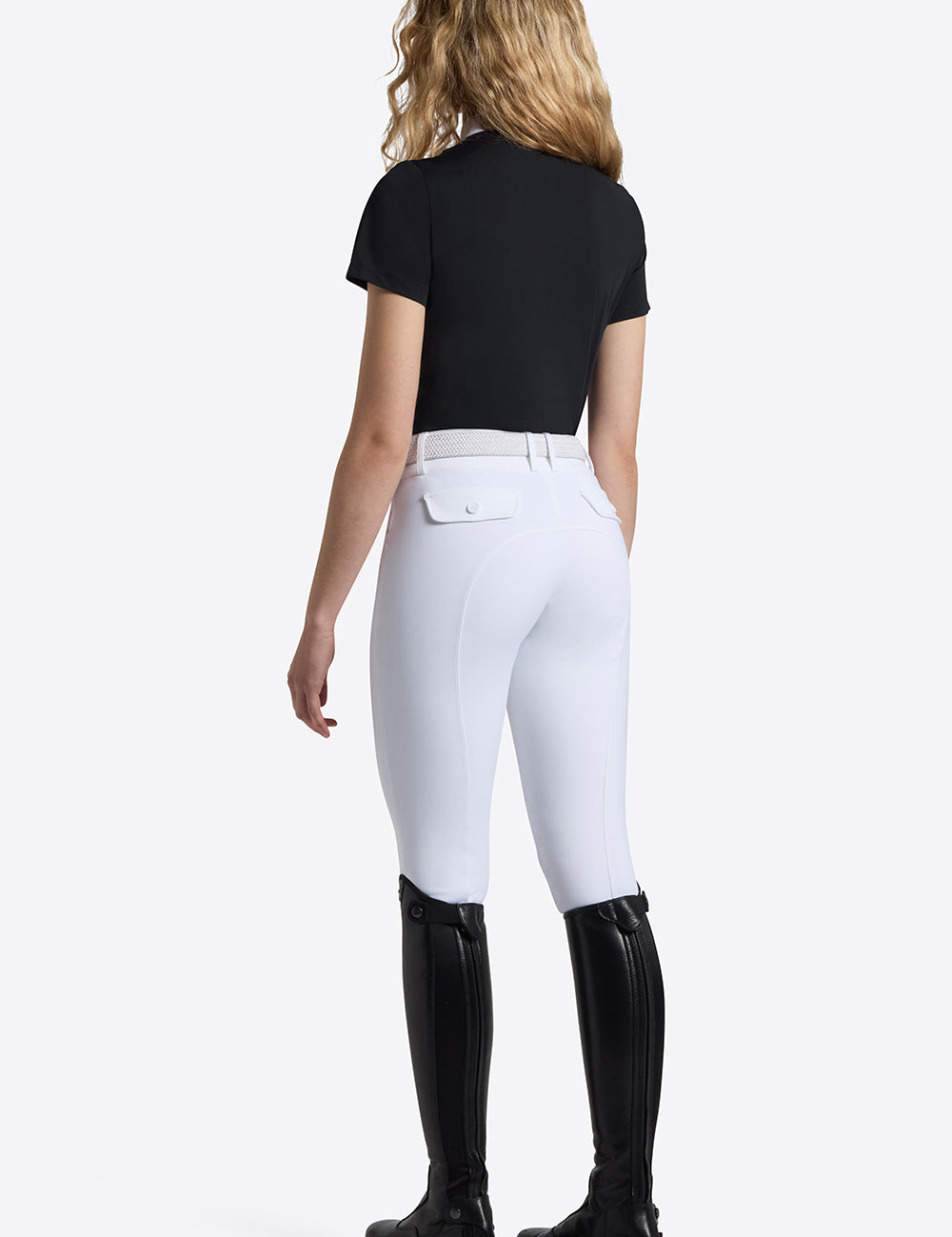 Rider's Gene Short Sleeve Jersey Competition Shirt in navy, back view, worn with white breeches and tall black riding boots