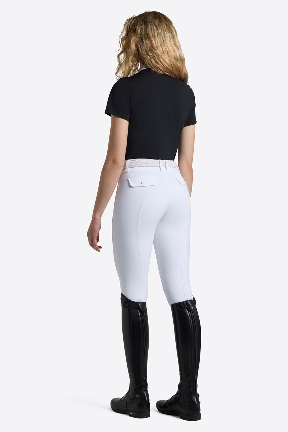 Rider's Gene Short Sleeve Jersey Competition Shirt in navy, back view, worn with white breeches and tall black riding boots