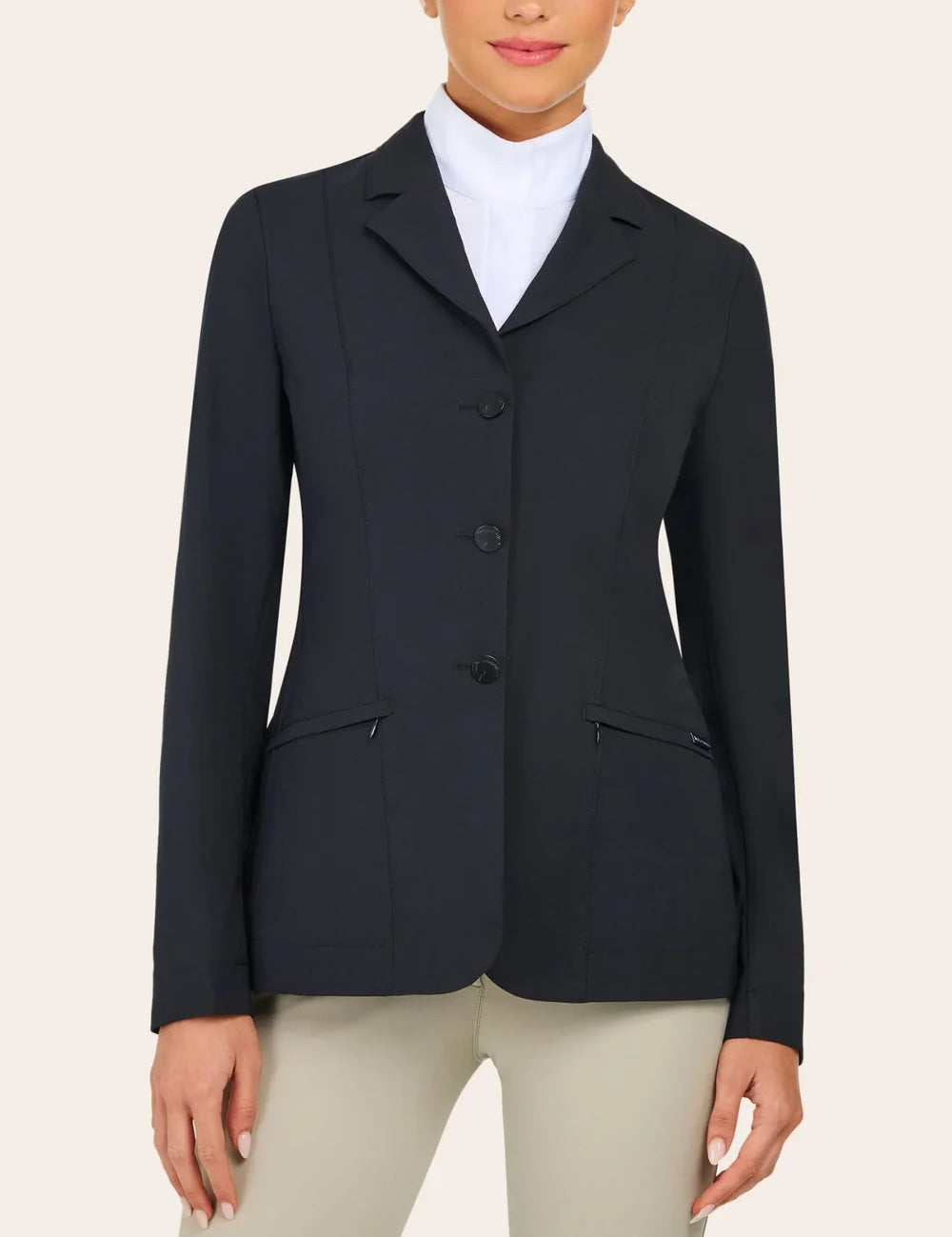 Front view of the RJ Classics Sloane Show Coat in black with a notched lapel, three-button front closure, and slanted zip pockets, shown over a white high-collar show shirt and light tan breeches against a plain light background.