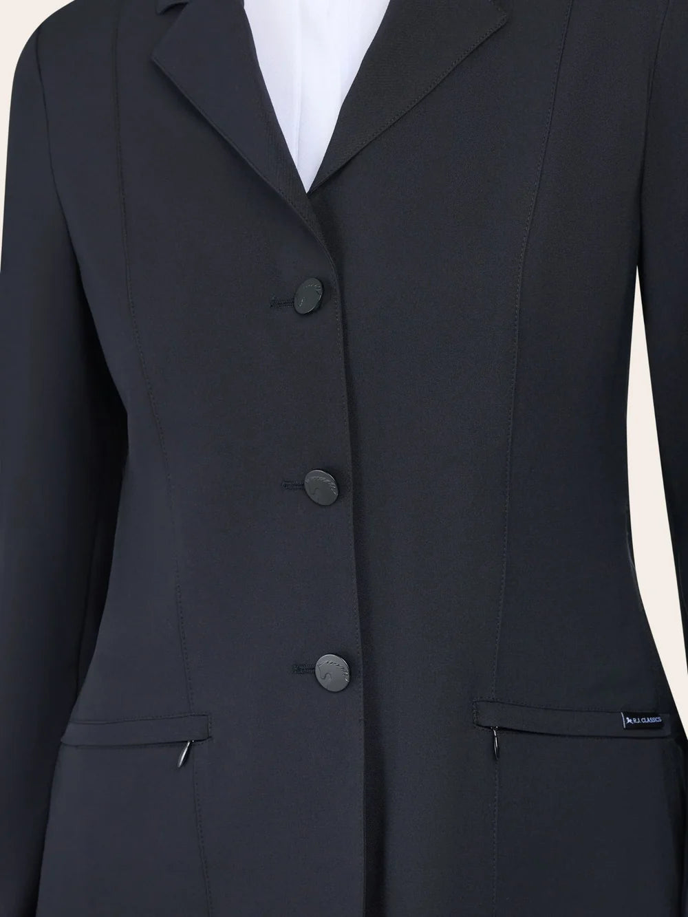 Close-up of the RJ Classics Sloane Show Coat in black showing the notched lapel, three-button front closure, and slanted zip pockets with a small RJ Classics tag.