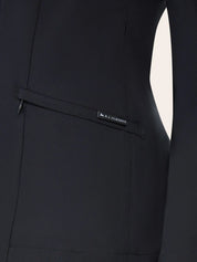 Close-up of the RJ Classics Sloane Show Coat in black showing a slanted zip pocket with an RJ Classics fabric tag and stitched seam lines on the jacket front.