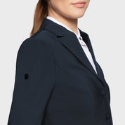 Close-up side view of a female model wearing the Navy Samshield Alexia Show Coat on a plain background