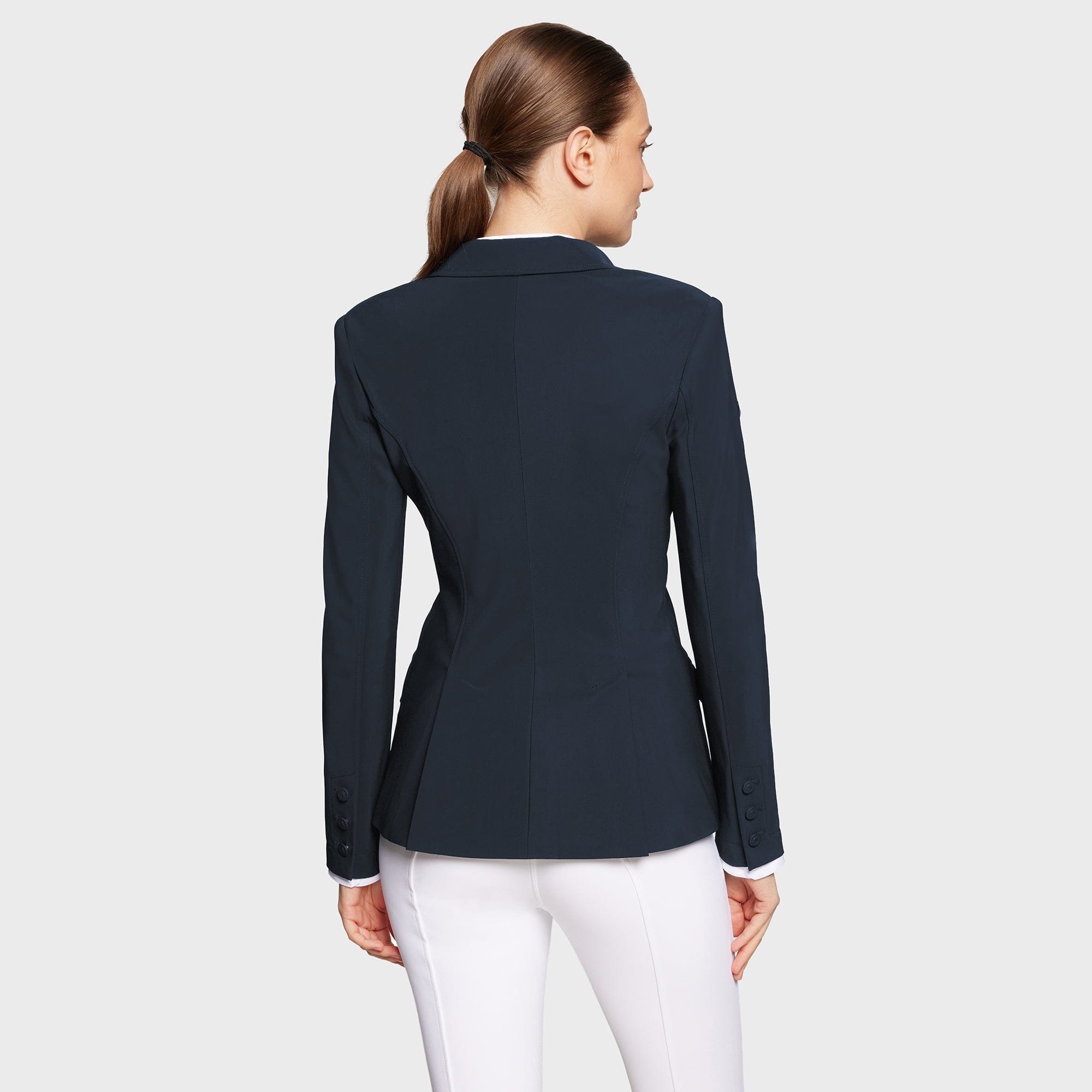 Back view of a female model wearing the Navy Samshield Alexia Show Coat on a plain background