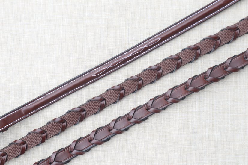 Side-by-side front and back views of the Red Barn Stealth Reins on a textured background