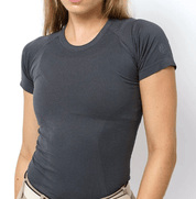 Front view of a female model wearing the Slate TKEQ Kennedy Seamless Short Sleeve Shirt 2.0 on a white background
