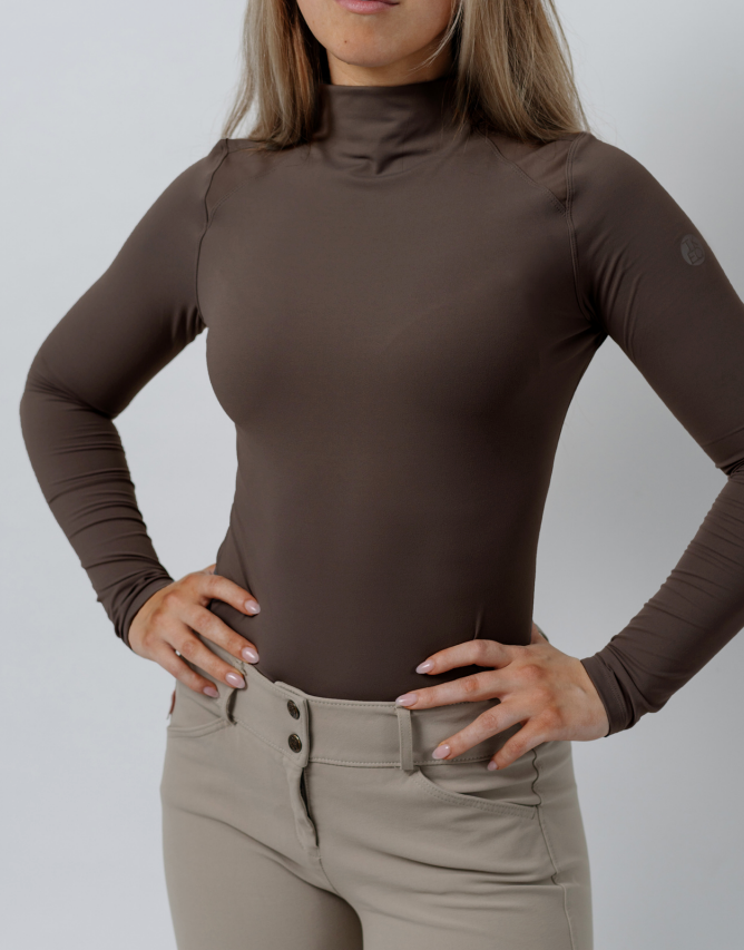 Front view of a female model wearing the Espresso TKEQ Chloe High Collar Technical Top on a plain background