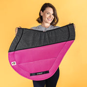 Side view of a model holding the pink Ecogold Secure Cross Country Pad on a yellow backgorund