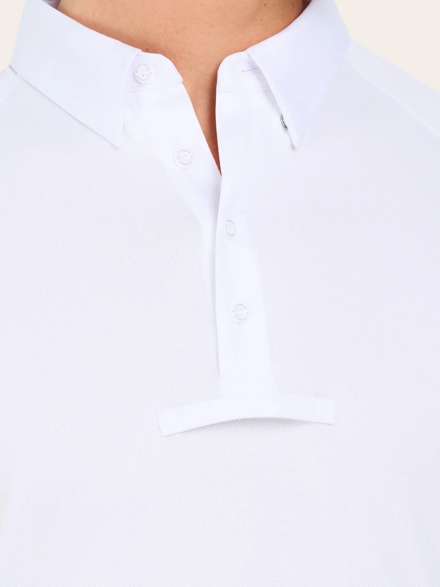 Close-up front view of the button placard on the white RJ Classics Tyler Show Shirt