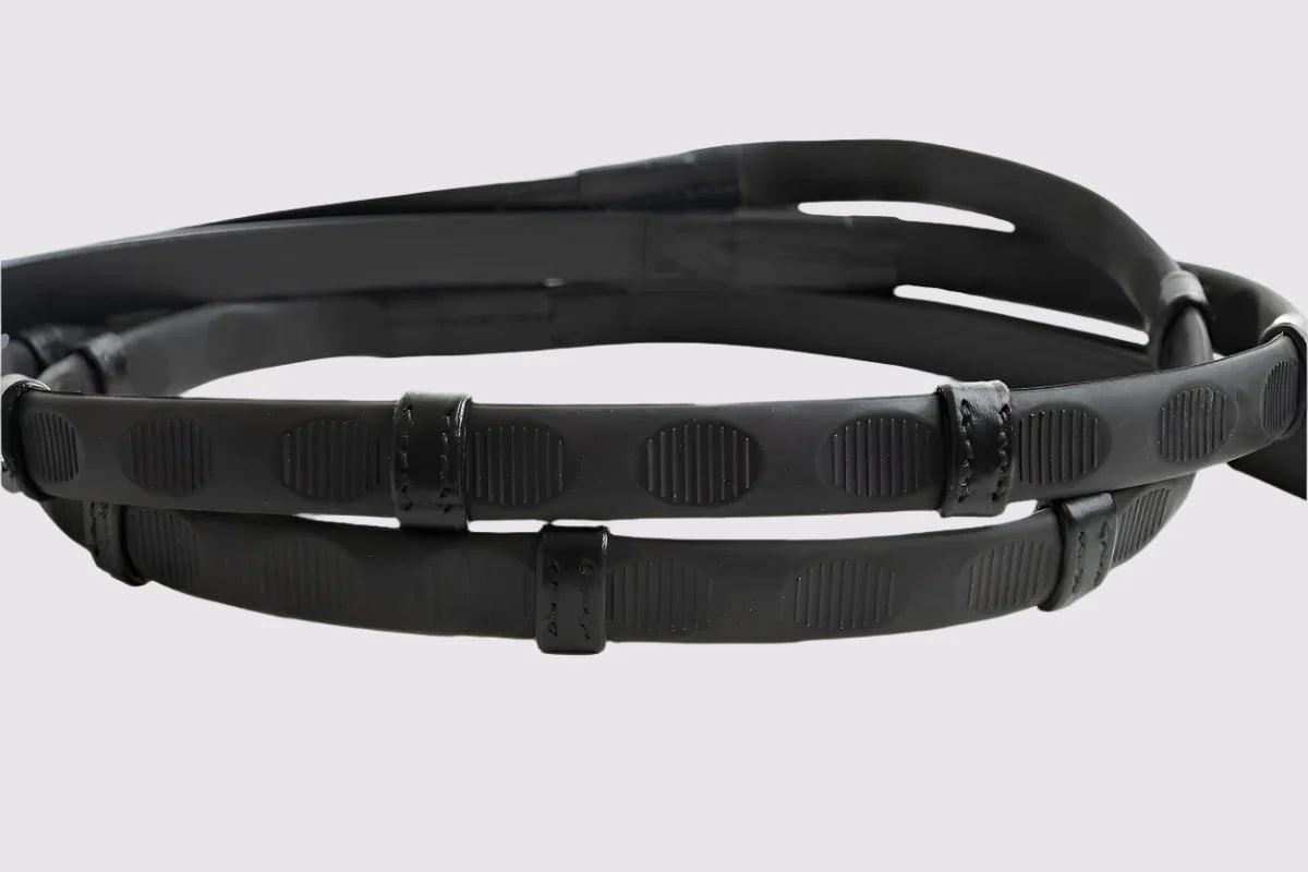 A pair of black Correct Connect Thumb Grip Reins on a white background
