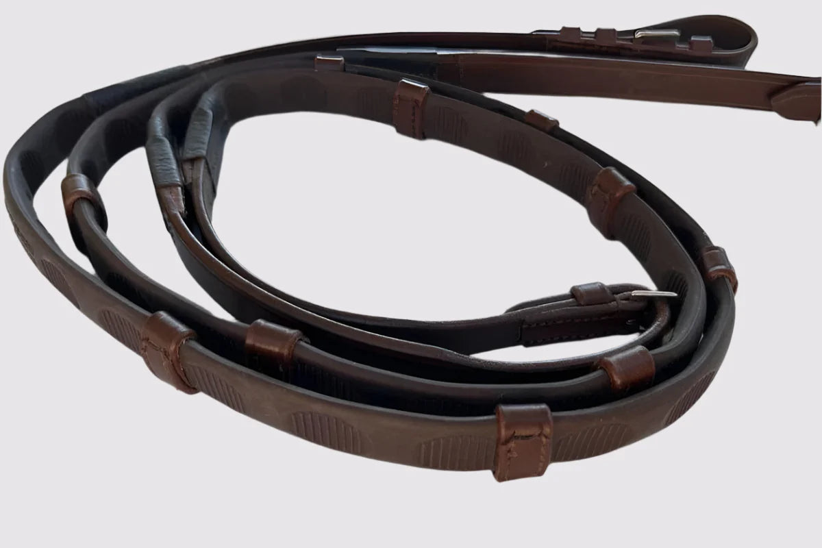A pair of brown Correct Connect Thumb Grip Reins on a white background