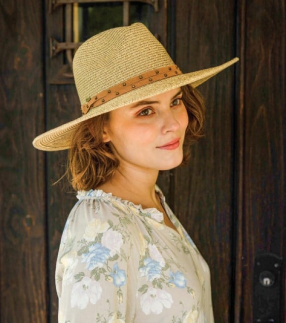Angled front view of a female model wearing the Natural Dorfman Milano Misa Hat on a white background