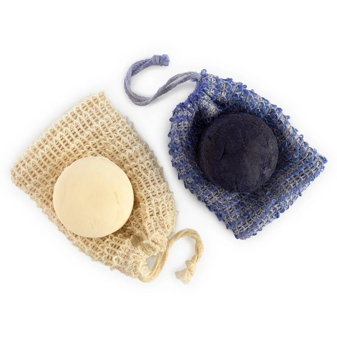 Round shampoo bar with exfoliating soap bags on white background