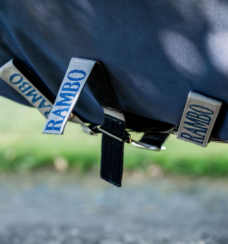 Close-up view of the belly closures on the navy Horseware Rambo 1680D Turnout 100g