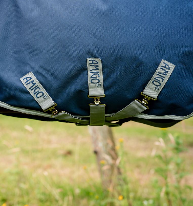 Close up view of the crossed surcingles on the navy Horseware Amigo 1200D Plus Turnout 250g 