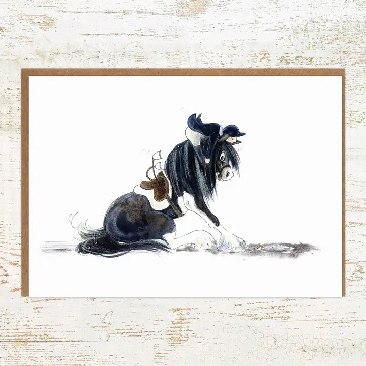View of the There Be Dragons Pony Nut Greeting Card on a white washed wood background