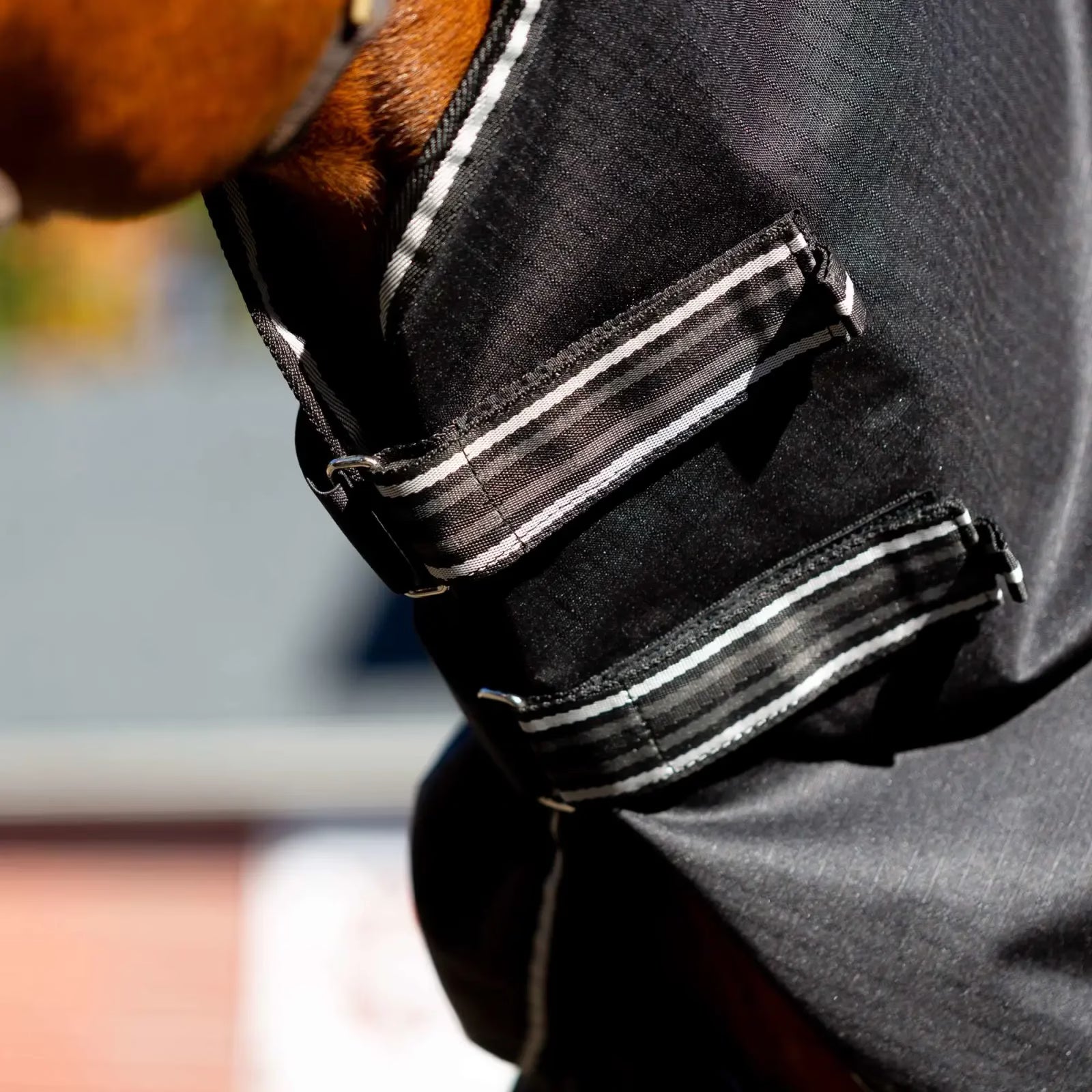 Close-up view of the velcro closures on the black Equinavia Norse Turnout Hood 0g