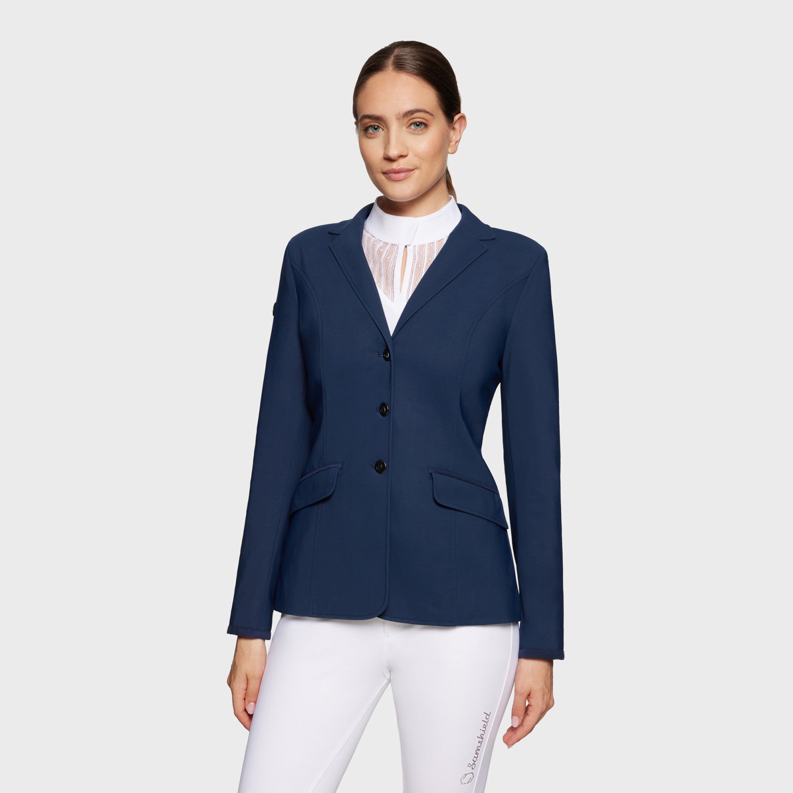 Front view of a model wearing the navy blue Samshield Alix Show Coat on a plain background