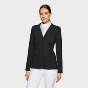 Front view of a female model wearing the black Samshield Alix Show Coat on a plain background