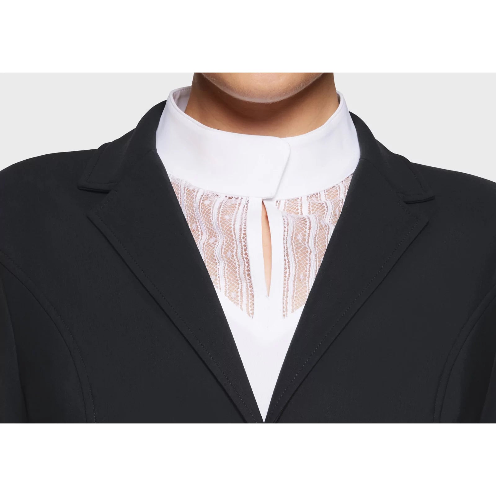 Close up front view of the lapel on the black Samshield Alix Show Coat on a plain background