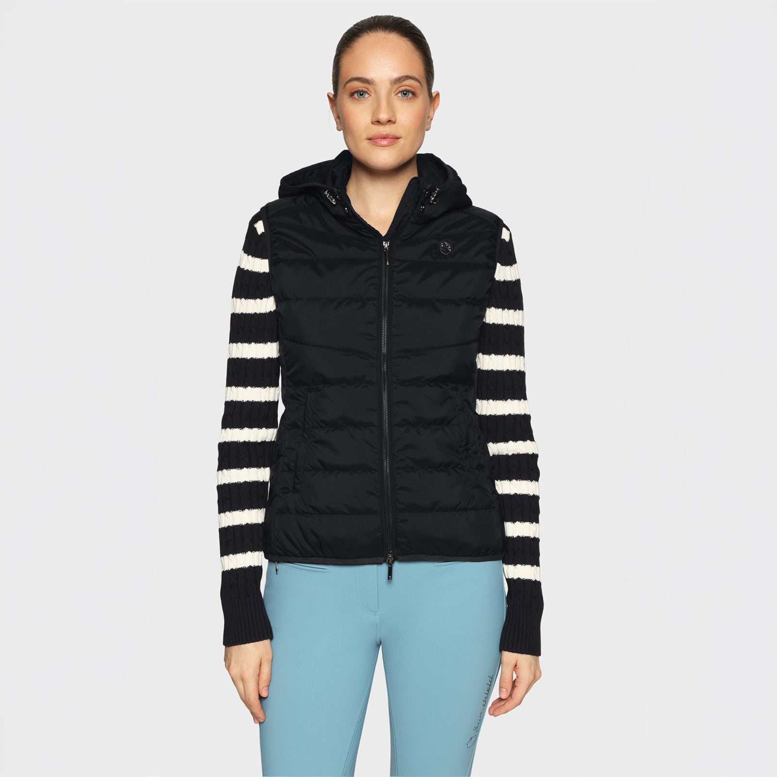 Front view of a female model wearing the black Samshield Alta Badia Vest on a plain background