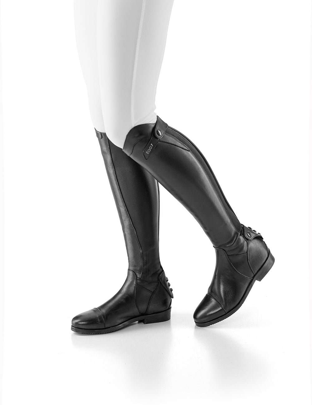 Side view of a model wearing the black Ego 7 Aries Dress Boots on a white background