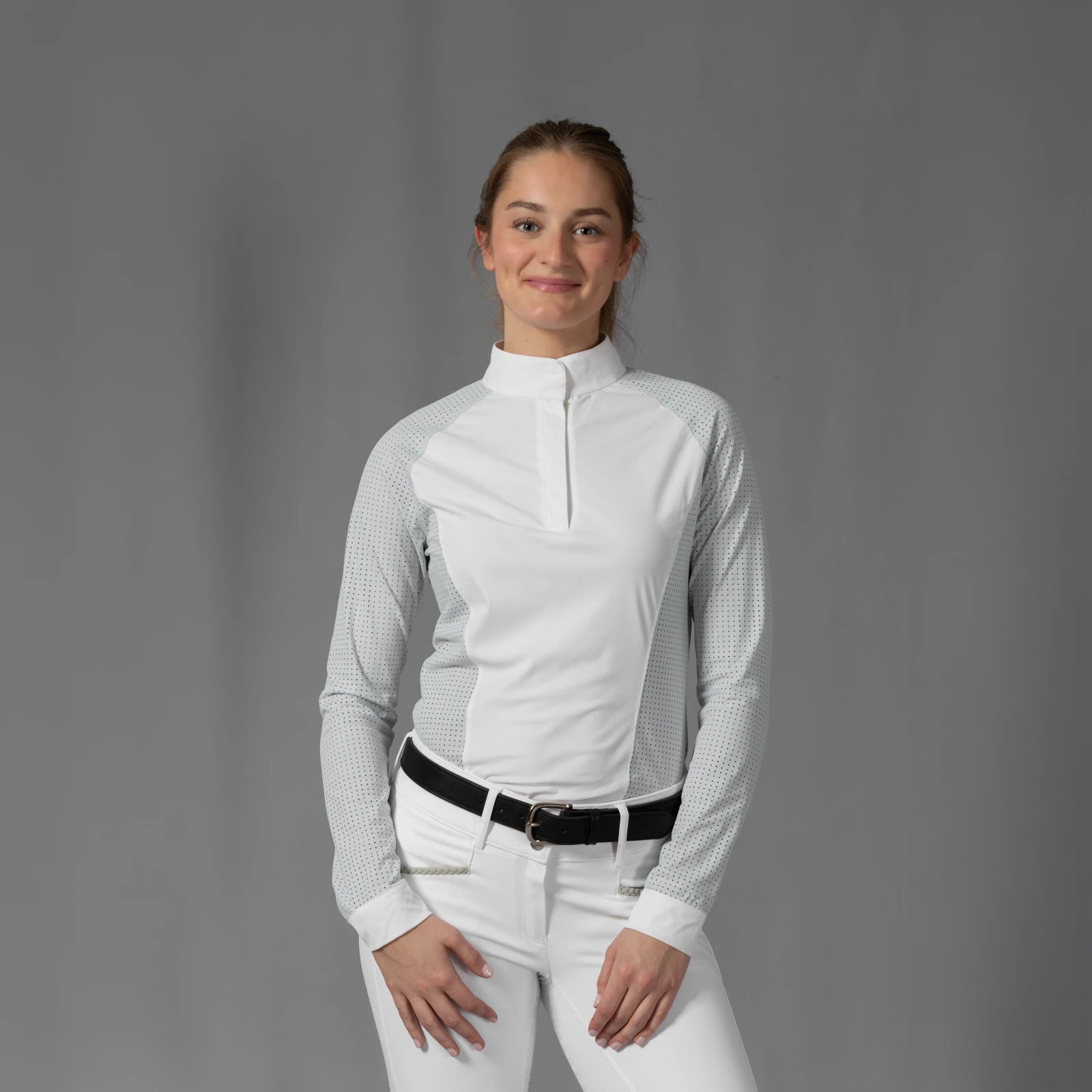 Front view of a model wearing the Equinavia Sara Womens Perforated Long Sleeved Show Shirt in light blue and white on a gray background