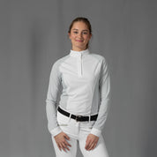 Front view of a model wearing the Equinavia Sara Womens Perforated Long Sleeved Show Shirt in light blue and white on a gray background