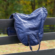 Side view of the navy Horze Saddle Bag sitting on a black fence outside