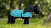 Aqua toy fleece cooler on a black stuffed animal horse outside