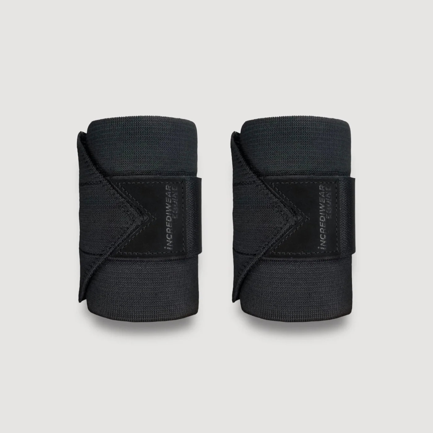 View of a pair of black Incrediwear Circulation Exercise Bandages on a plain background