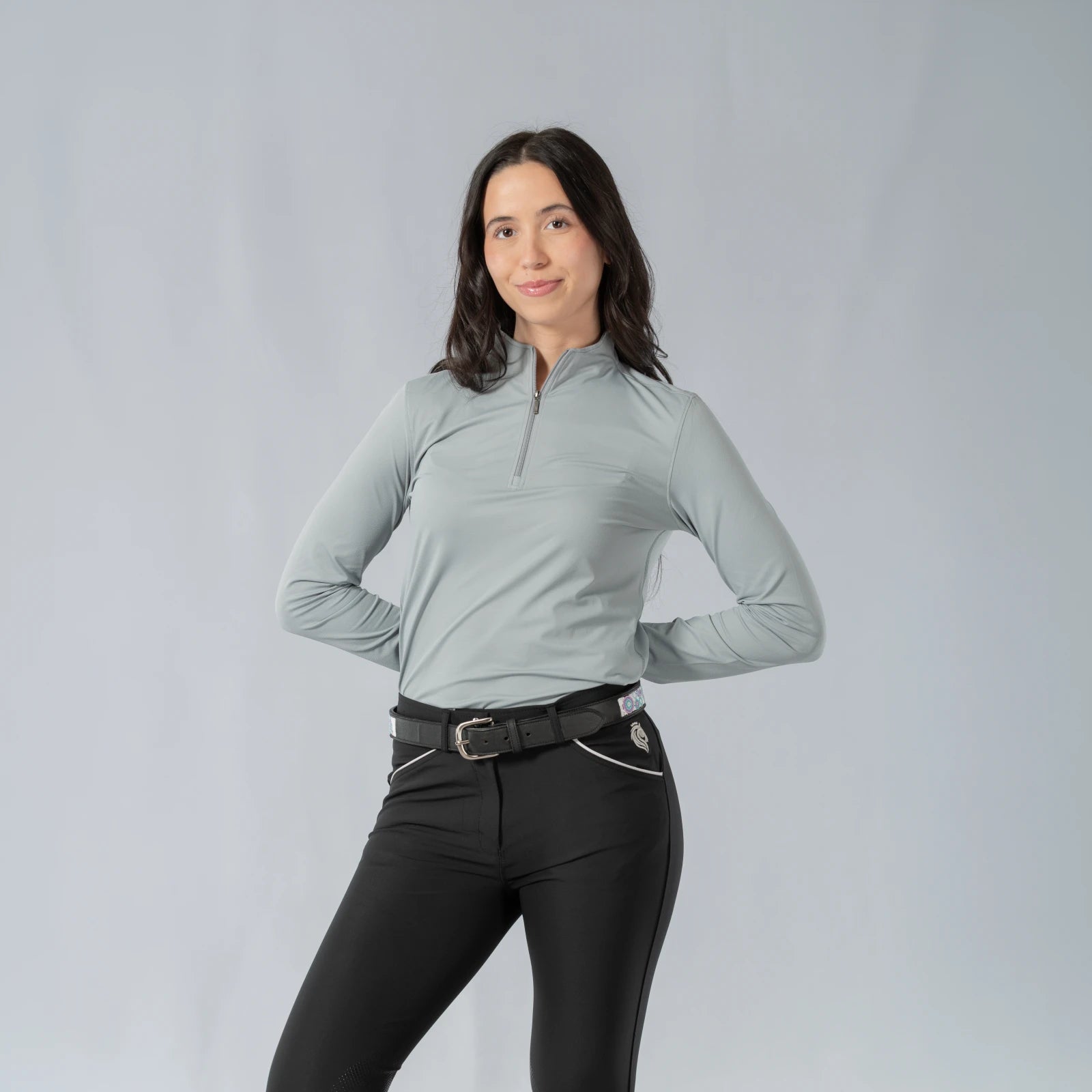 Front view of a model wearing the Equinavia Kari Womens Long Sleeve Sun Shirt with NordicAir Tech in gray on a gray background
