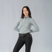 Front view of a model wearing the Equinavia Kari Womens Long Sleeve Sun Shirt with NordicAir Tech in gray on a gray background