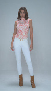 Full body front view of a female model wearing the Dancing Equestrian L'Orange Baroque Sleeveless Shirt and white breeches on a plain background