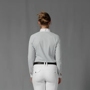 Back view of a model wearing the Equinavia Sara Womens Perforated Long Sleeved Show Shirt in light blue and white on a gray background