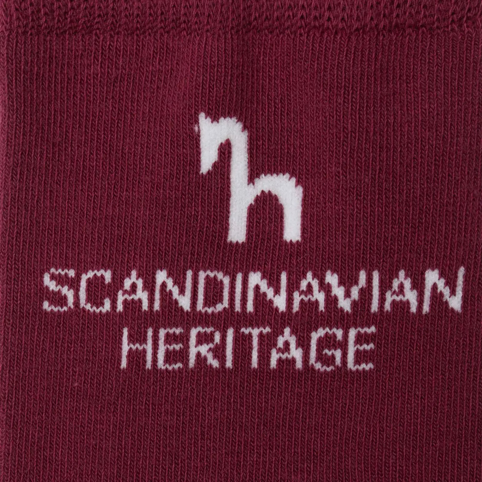 Close-up view of the Scandinavian Heritage horse logo on the red Horze Noya Knee Socks