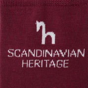 Close-up view of the Scandinavian Heritage horse logo on the red Horze Noya Knee Socks