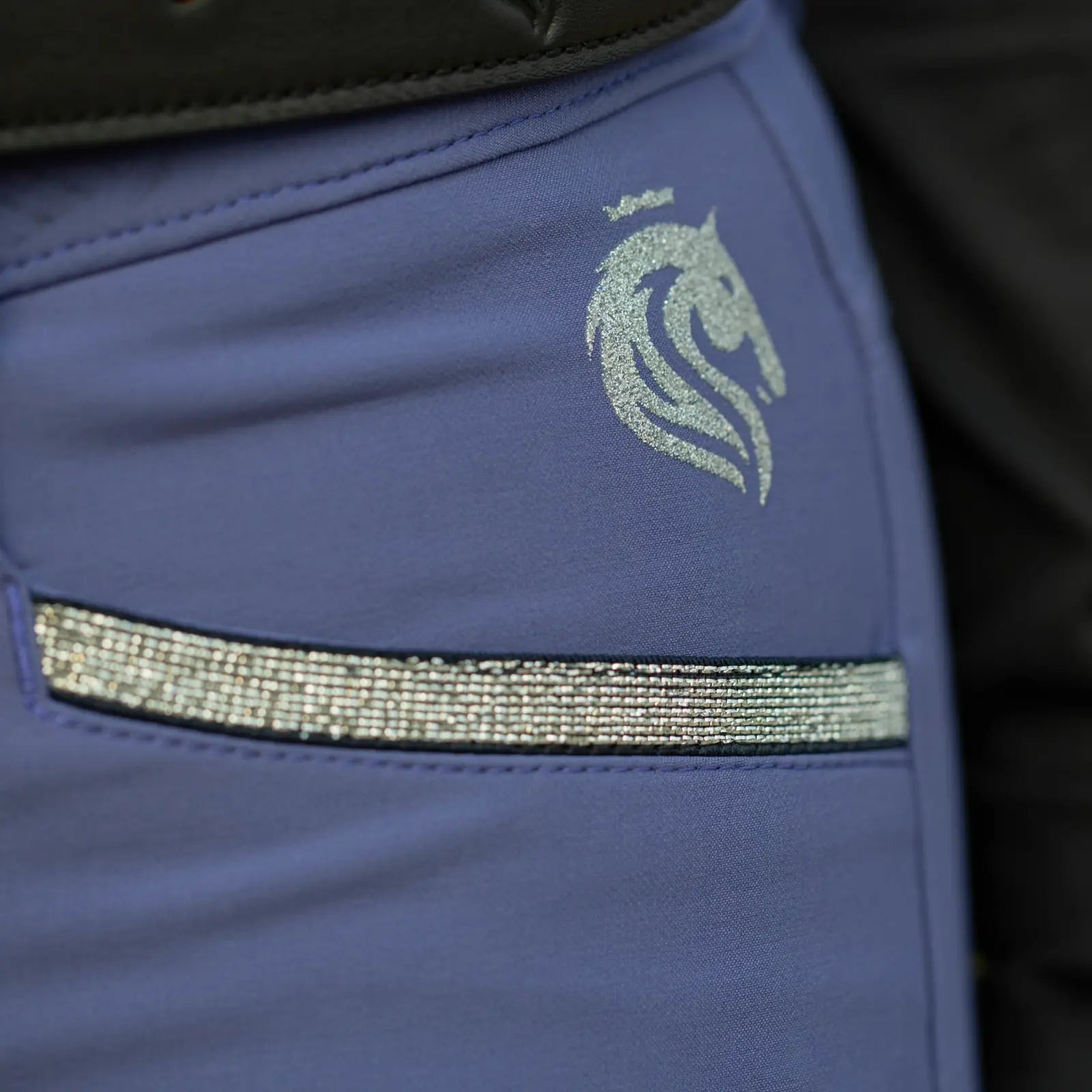 Close-up view of the front pocket detail on the blue Equinavia Kristina Knee Patch Breeches