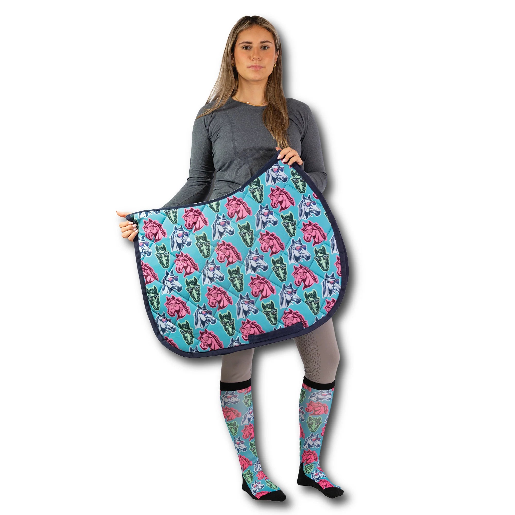 Front view of a female model holding a California Dreamin' Dreamers Saddle Pad and wearing matching Dreamers & Schemers Pair & A Spare Boot Socks on a plain background