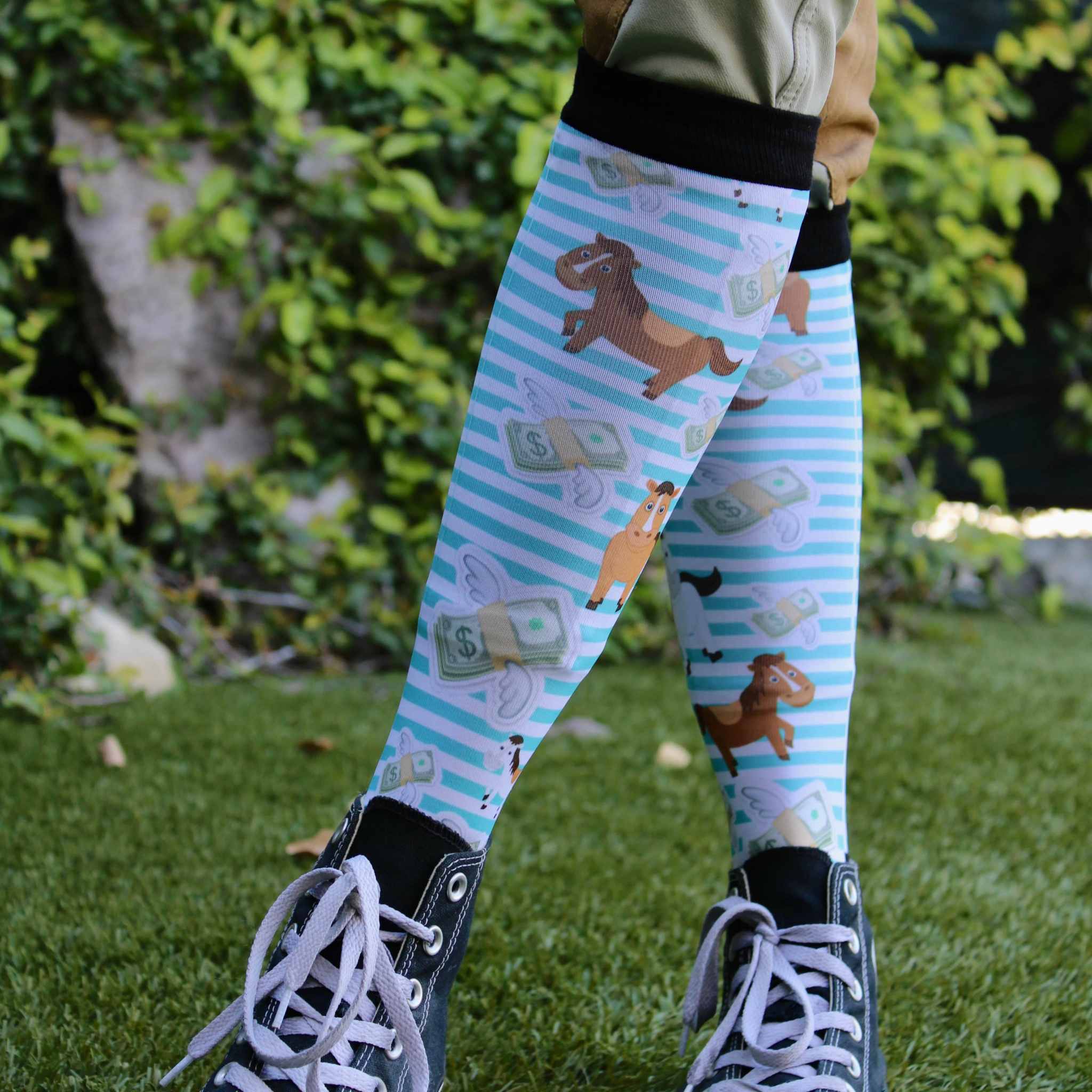 Front view of someone standing outside with legs crossed wearing the Cash Money Dreamers & Schemers Pair & A Spare Boot Socks 