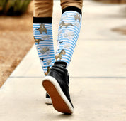 Back view of someone walking on a sidewalk wearing the Cash Money Dreamers & Schemers Pair & A Spare Boot Socks 