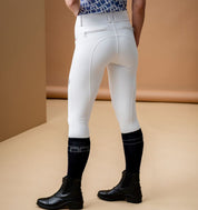 Model wearing Horseware Alessandro Albanese Aria Full Seat Mid Rise Breech in core white with black riding boots, back view