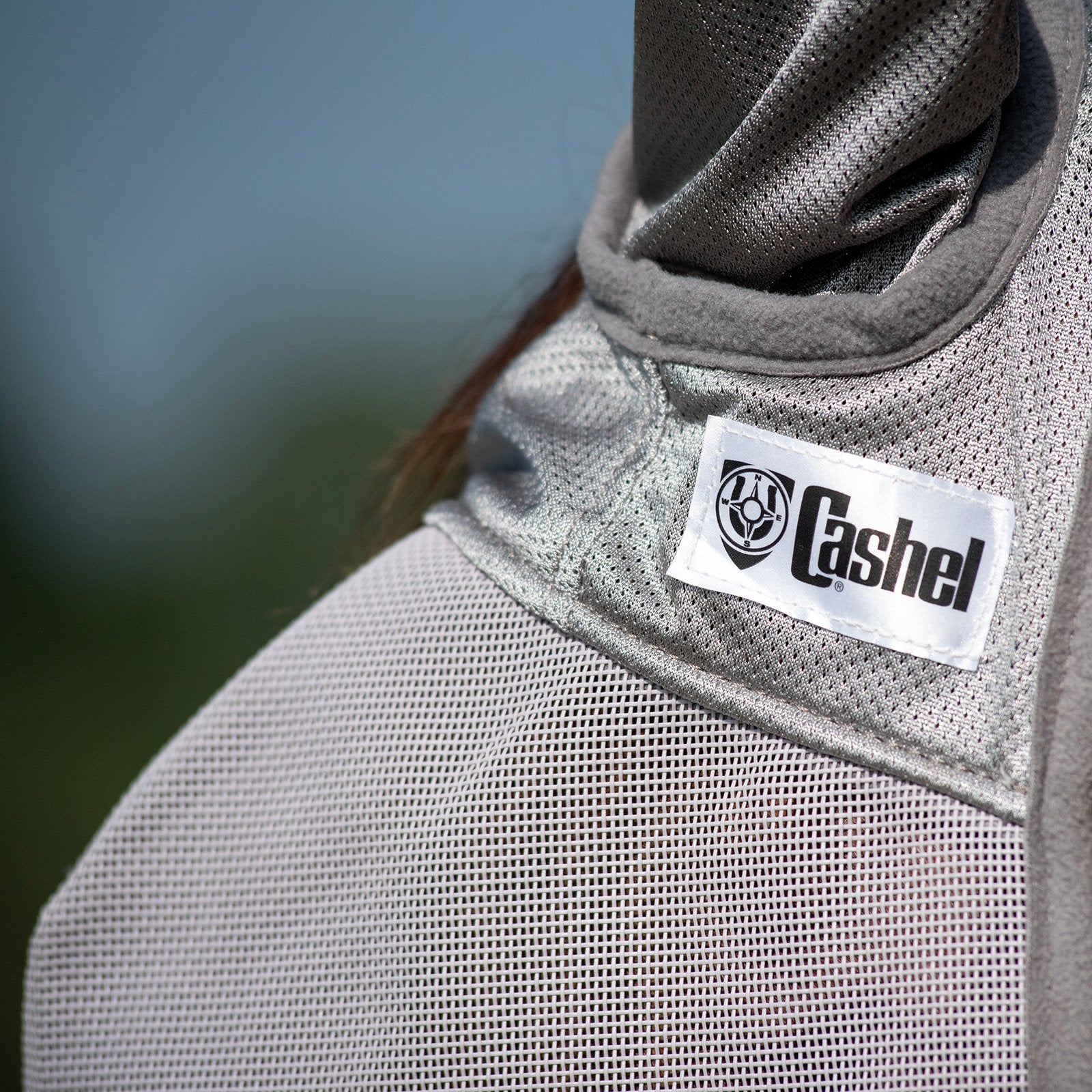 Close-up view of the Cashel logo on the gray Cashel Crusader Fly Mask with Long Nose and Ears