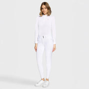 Full body front view of a female model wearing the white Samshield Clara Premium Full Grip Breeches and white top on a plain background